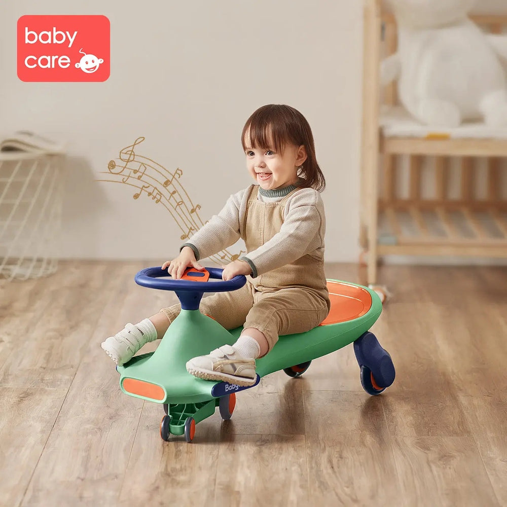 Bc Babycare Nyokiroad Wiggle Car; green ride-on toy with orange seat and blue steering wheel, toddler riding indoors.