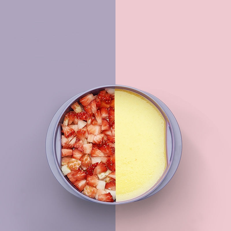BC Babycare portable travel food bowl, purple two-section design with sliced strawberries and yellow puree.