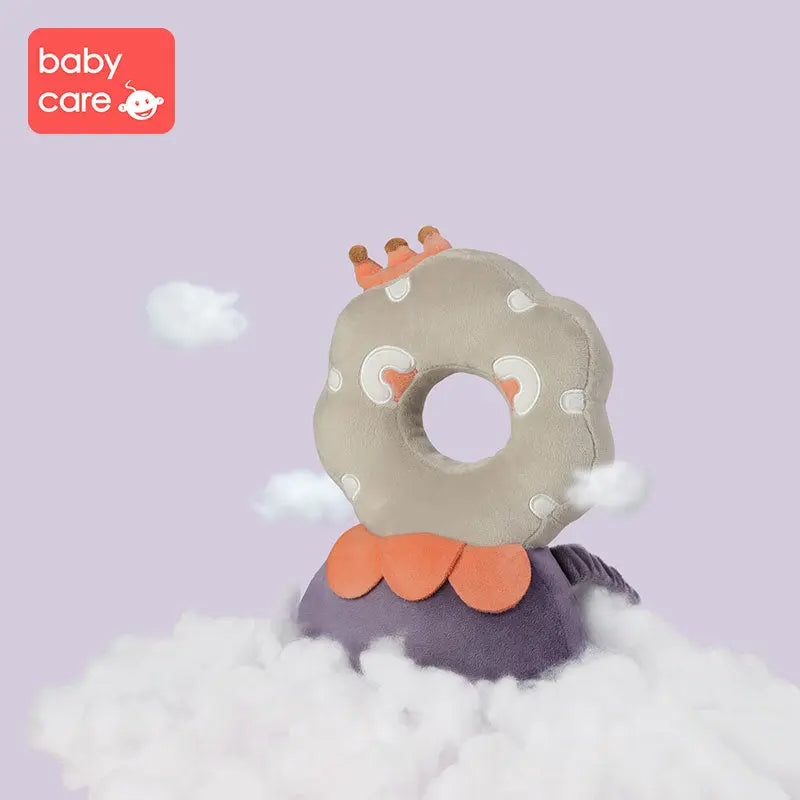 Bc Babycare Protective Cushion donut-shaped plush support pillow with crown accents, resting on a purple cloud.