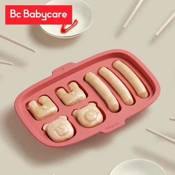 Bc Babycare Silicone Mold Rectangle in pink, showing six character- and sausage-shaped cavities for playful mealtimes.
