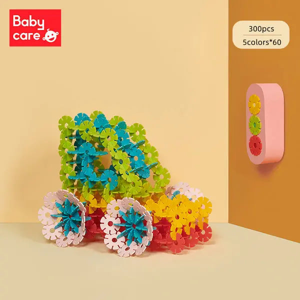 BC Babycare Snowflake Blocks interlocking gear blocks in green, blue, yellow, pink, stacked into a colorful construction.