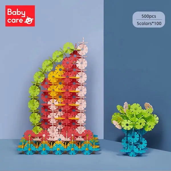 BC Babycare Snowflake Blocks tower built from 500-piece, five-color set beside a blue storage container.