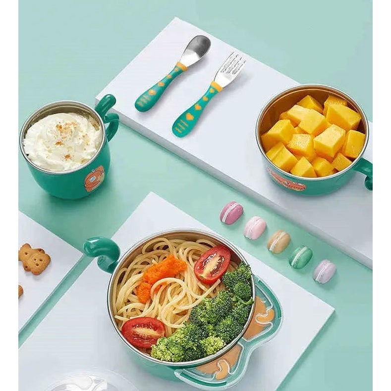 BC Babycare Stainless Steel Feeding Set 5Pcs in teal with yellow-dot handles; bowls, cup, utensils on a kid-friendly table.