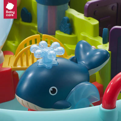 BC Babycare Water Park Toy Set; blue whale bath toy with translucent spout among bright multicolor play pieces