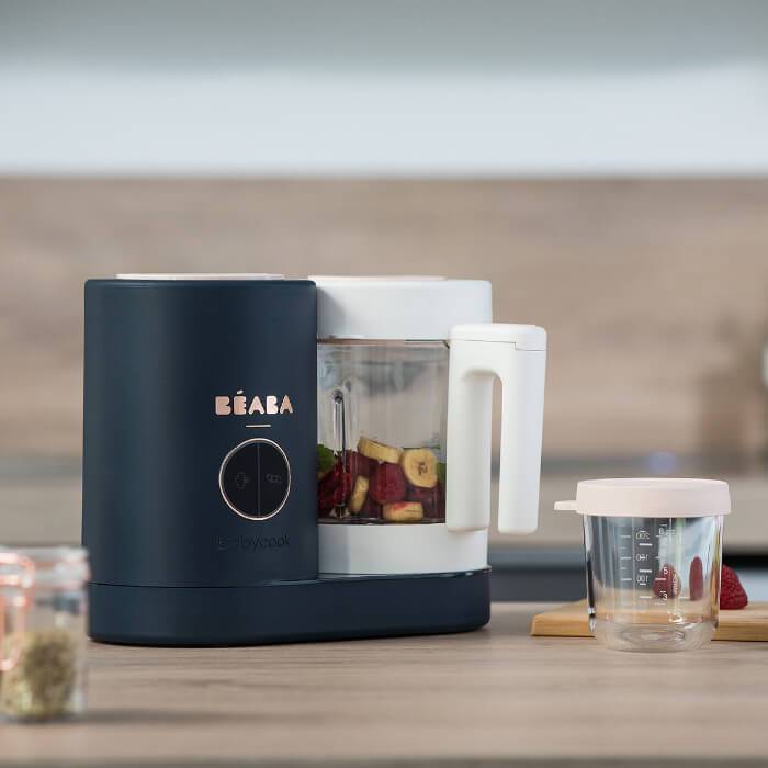 Beaba Babycook Neo Midnight food maker with white lid and glass jar on kitchen counter.