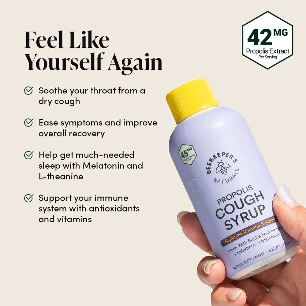 Beekeeper's Naturals Propolis Cough Syrup Nighttime 118 ml held in hand; purple bottle, yellow cap.