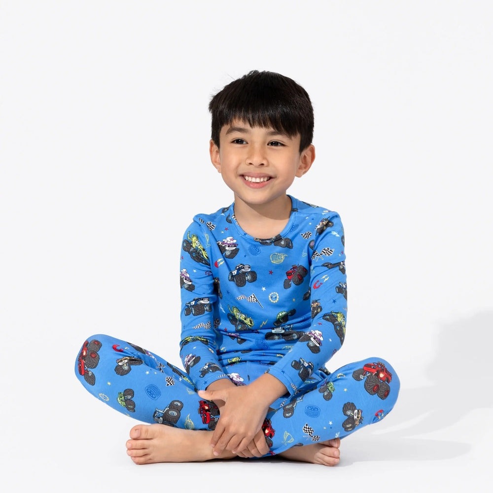 Bellabu Bear Bamboo Kids Pajamas Blaze and the Monster Machines blue long-sleeve top and pants; smiling boy sits cross-legged.