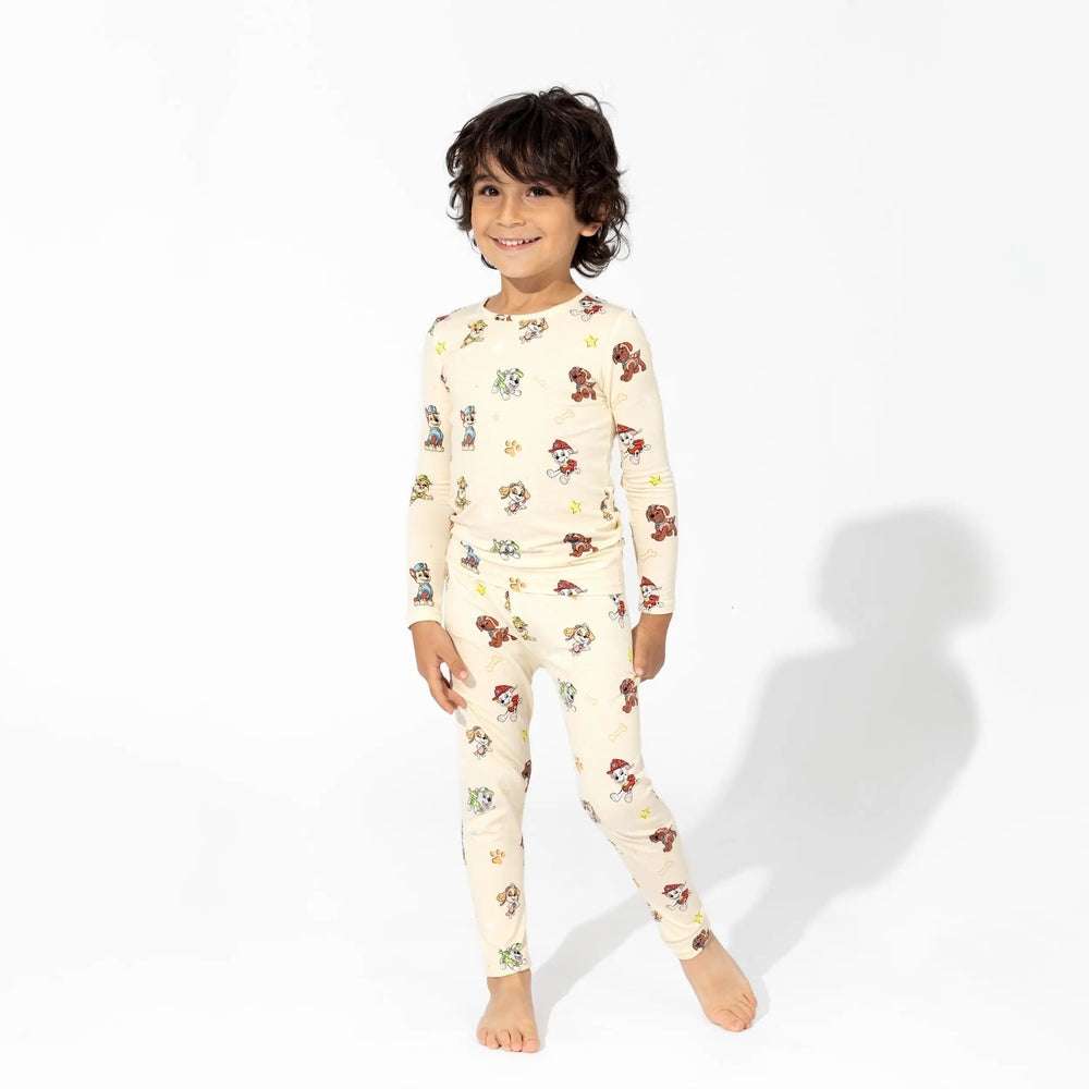 Bellabu Bear Bamboo Kids Pajamas Paw Patrol cream set worn by a smiling boy in long-sleeve top and leggings.