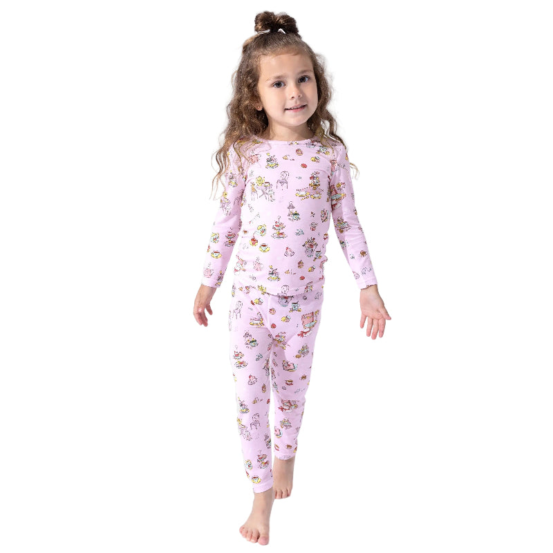 Bellabu Bear Bamboo Kids Pajamas Tea Party pink set worn by a smiling girl standing barefoot.