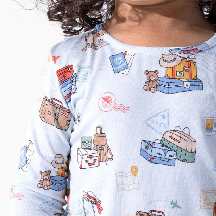 Bellabu Bear Bamboo Kids Pajamas Vintage Suitcases blue long-sleeve sleepwear worn by child, cozy travel-themed print.