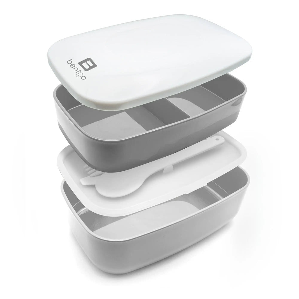 Bentgo Classic Two-Tier Lunch Box in white lid, grey trays; opened to reveal divided compartments and utensils.