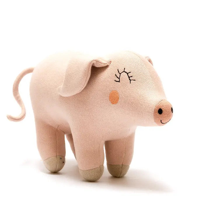 Best Years pink knitted pig plush toy in organic cotton, soft stuffed pig with a smiling face.