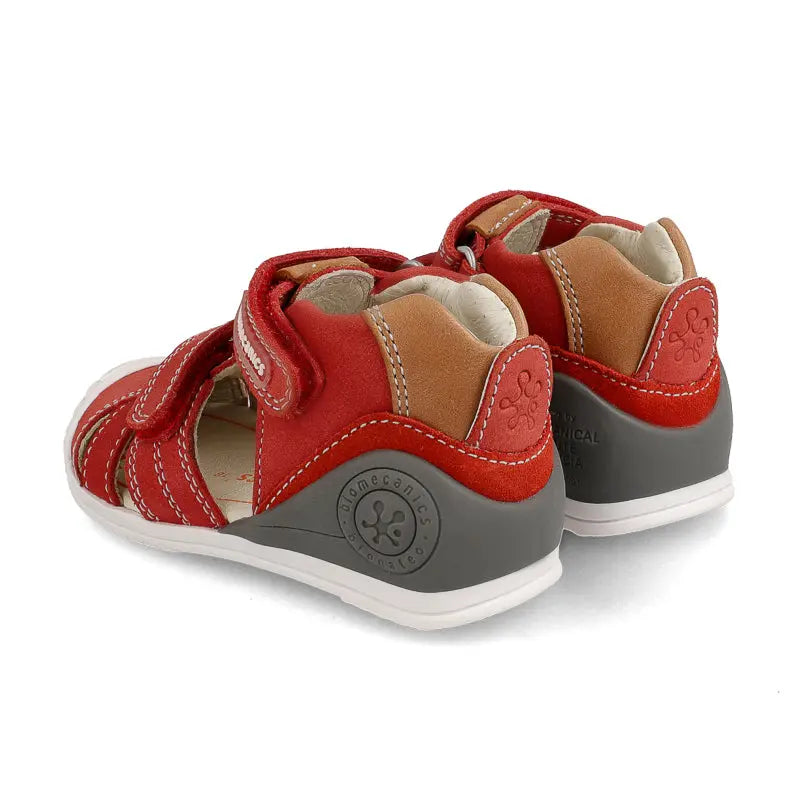 Biomecanics Sandalla Rojo Nobuck toddler sandals in red nubuck with gray heel, where Velcro straps fasten securely.