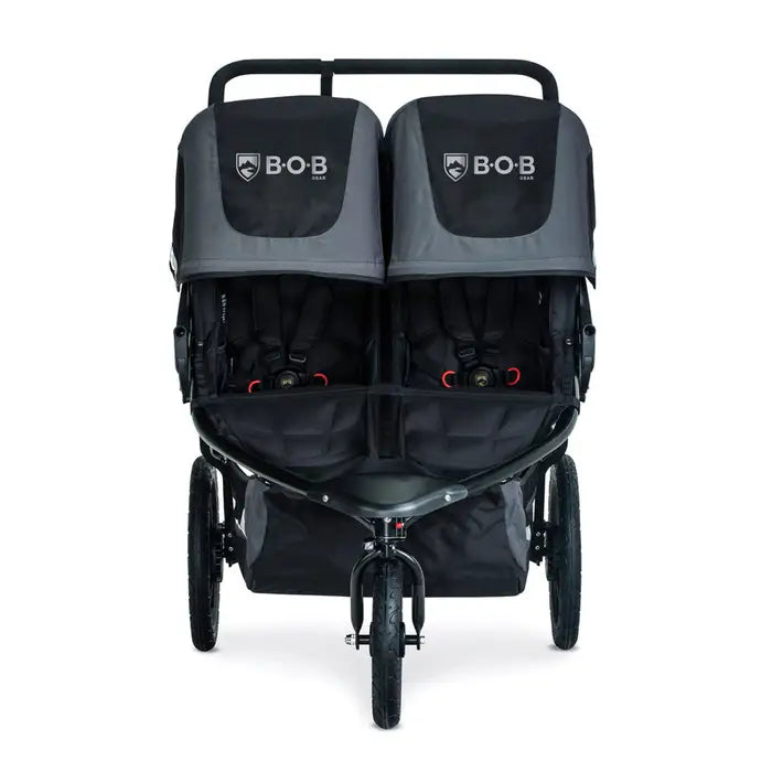 Bob Revolution Flex 3.0 Duallie Stroller, gray/black twin-seat stroller with fastened harnesses.