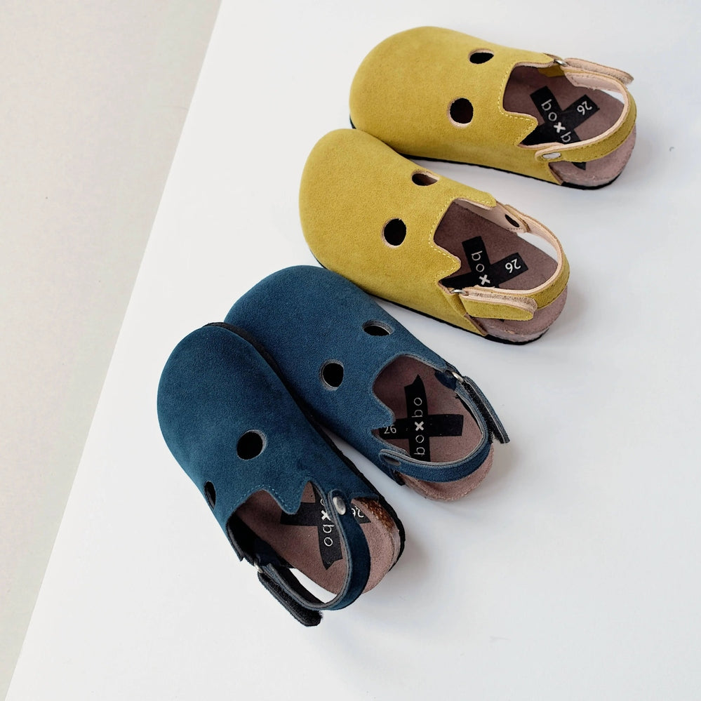 Boxbo Fox Cork Clog Unisex Sandal Mustard trio of cork-sole sandals with cutouts, shown on white surface.