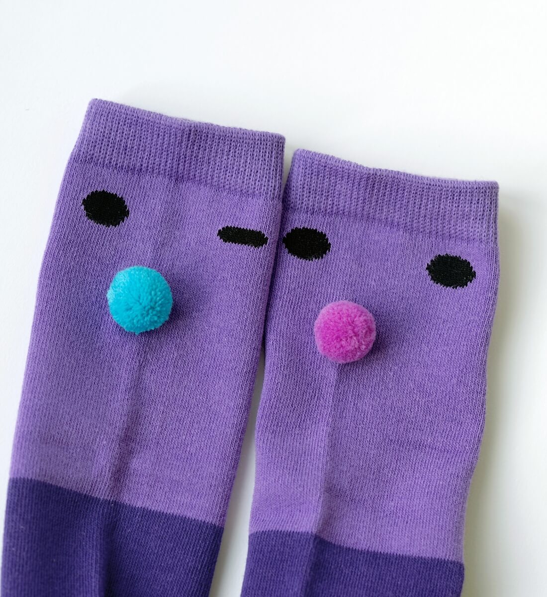 Boxbo Wistiti Violet high socks — close-up of purple knit, face details and pom-poms