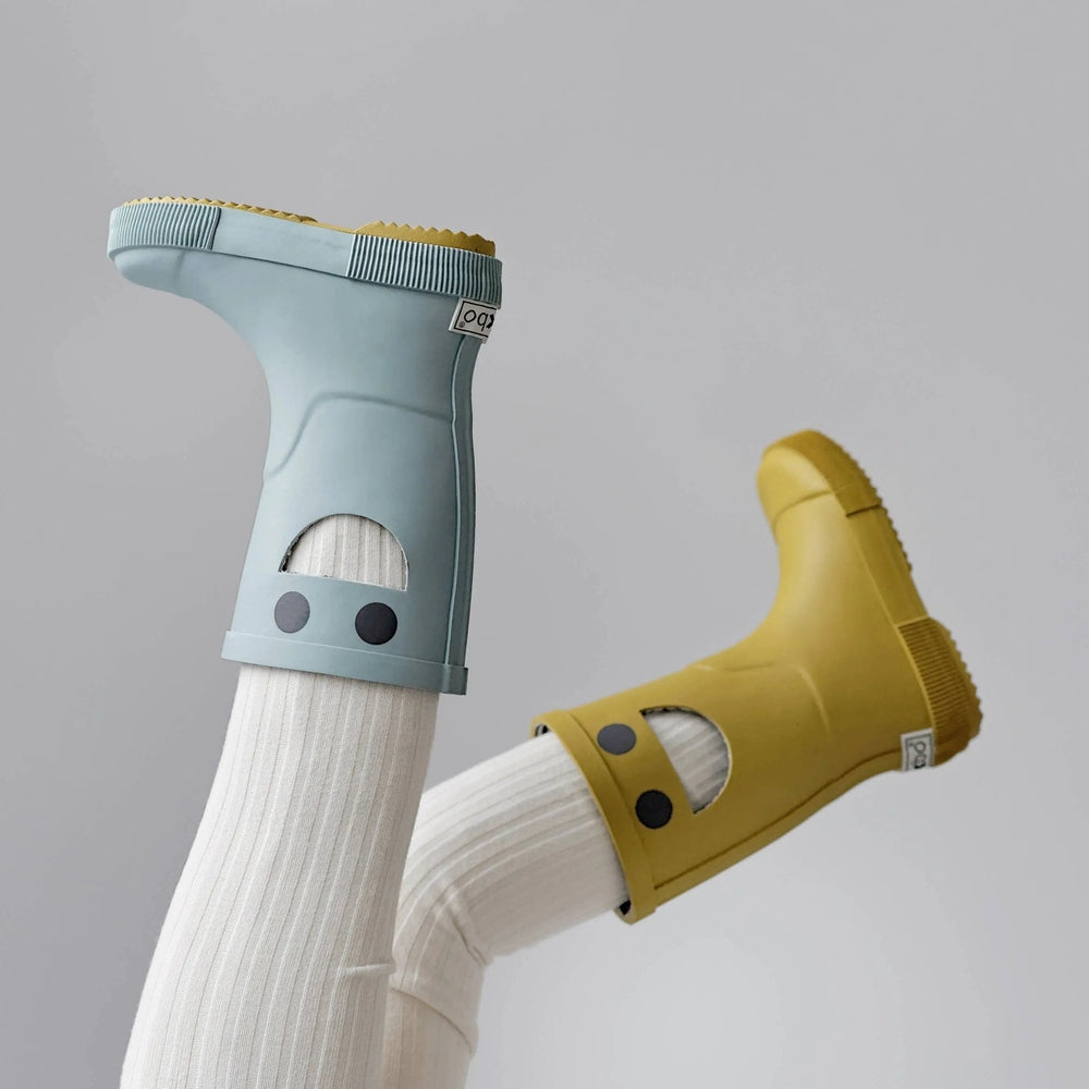 Boxbo Wistiti Rainboots Platine blue and yellow kids' waterproof rubber boots, worn on white tights with easy-on design