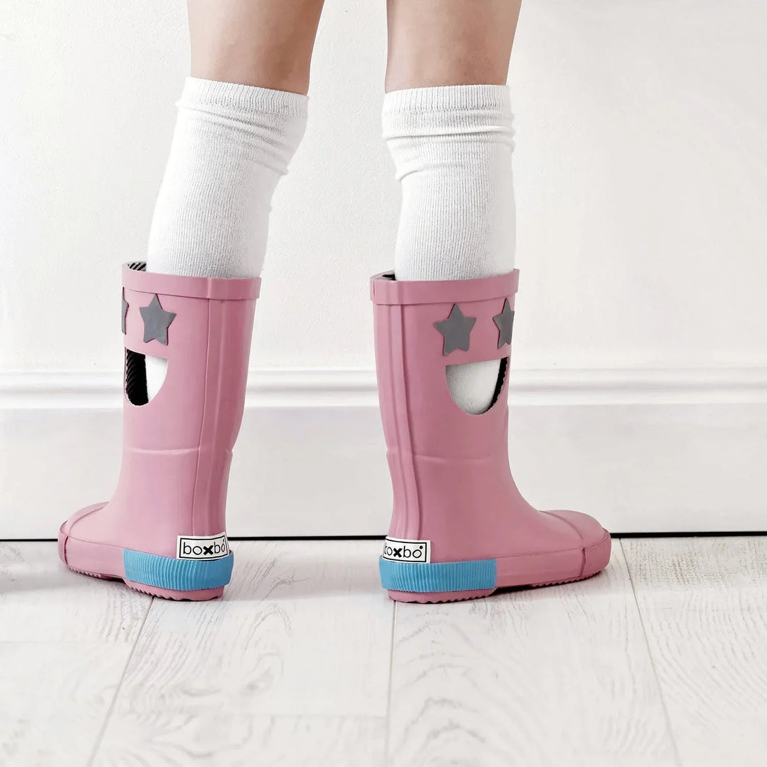 Boxbo Wistiti Star Pink rain boots worn with white socks, showing pink boots from the back and side