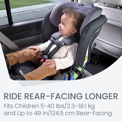 Britax Poplar Convertible Car Seat, dark gray, rear-facing with a toddler securely buckled in.