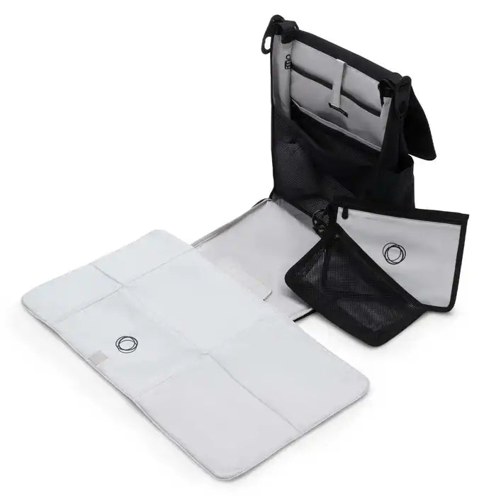 Bugaboo Changing Backpack shows white changing pad spread out and interior mesh pockets for organized on-the-go diaper storage.