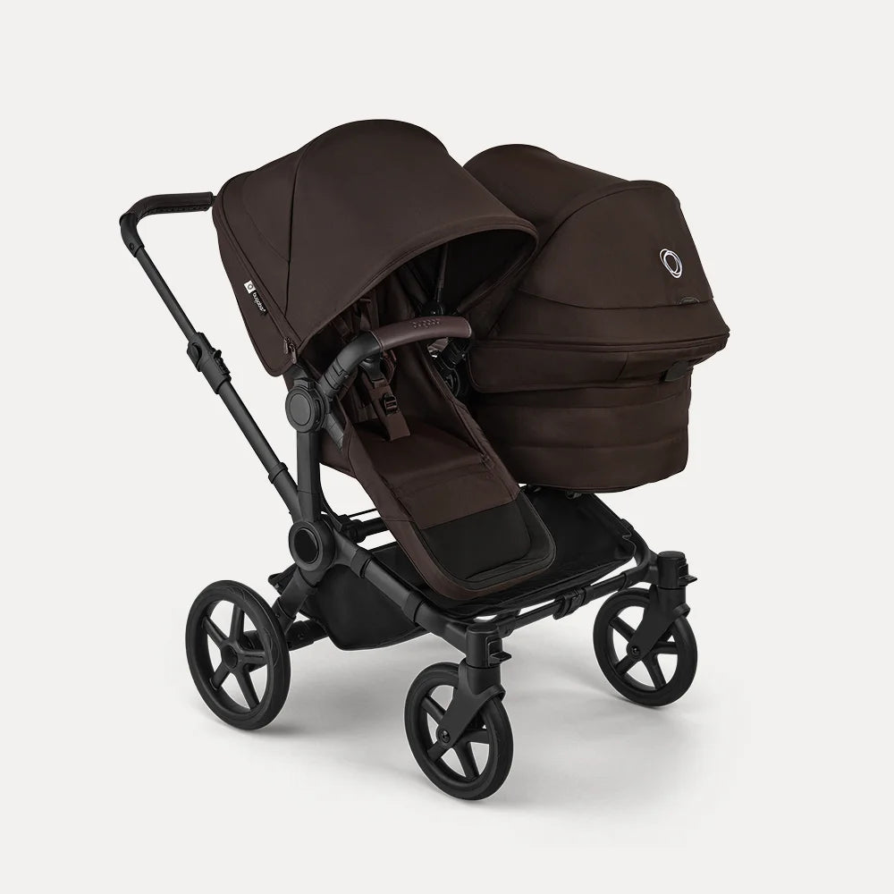 A Bugaboo Donkey 6 stroller in double configuration, featuring a seat and a bassinet. The fabrics are in Cocoa Brown.