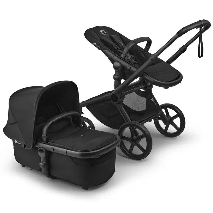 Bugaboo Fox 5 Renew Complete Stroller with bassinet in black; parent pushes the stroller with large wheels.
