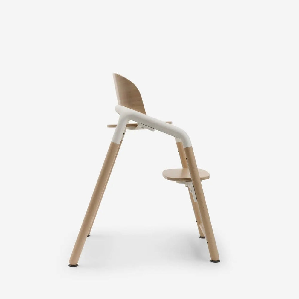 Bugaboo Giraffe Complete High Chair Set with natural wood legs and white frame, featuring a curved backrest shown in use-ready design.