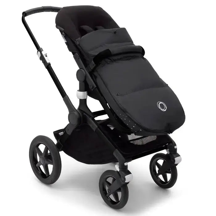 Bugaboo Performance Winter Footmuff on a black stroller, padded and weatherproof, keeping baby warm.