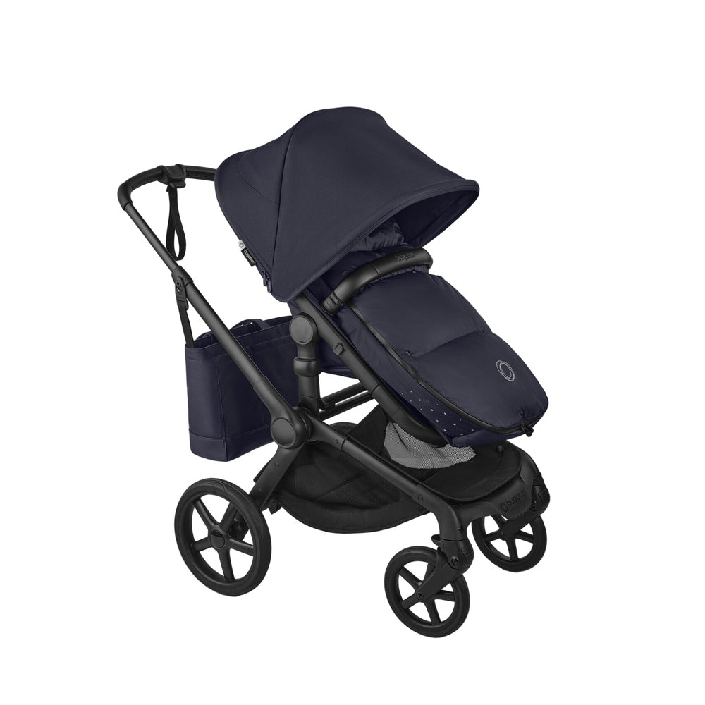 Bugaboo THERMOLITE Performance Footmuff in navy, zipped to a stroller seat for warm winter strolls.