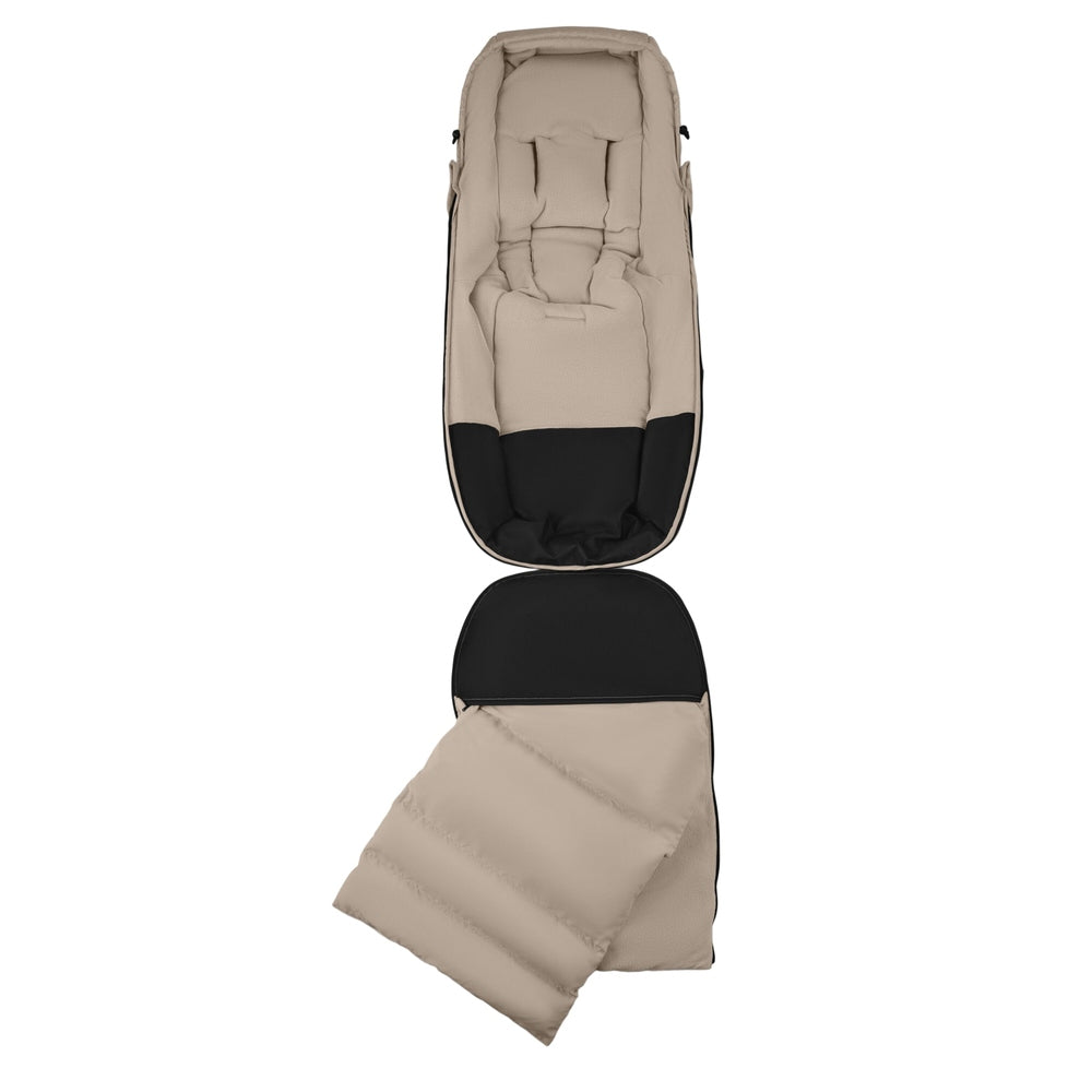 Bugaboo THERMOLITE Performance Footmuff in beige with black lining, opened to show quilted warmth for cold strolls.