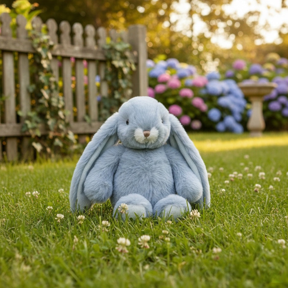 Bukowski Bears Junior Kanini Plush Bunny in Pearl Blue sitting on green lawn