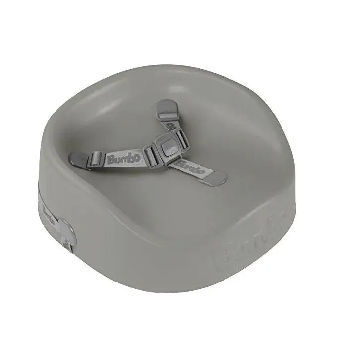 Bumbo Booster Seat in gray with adjustable straps fastened to secure a child.