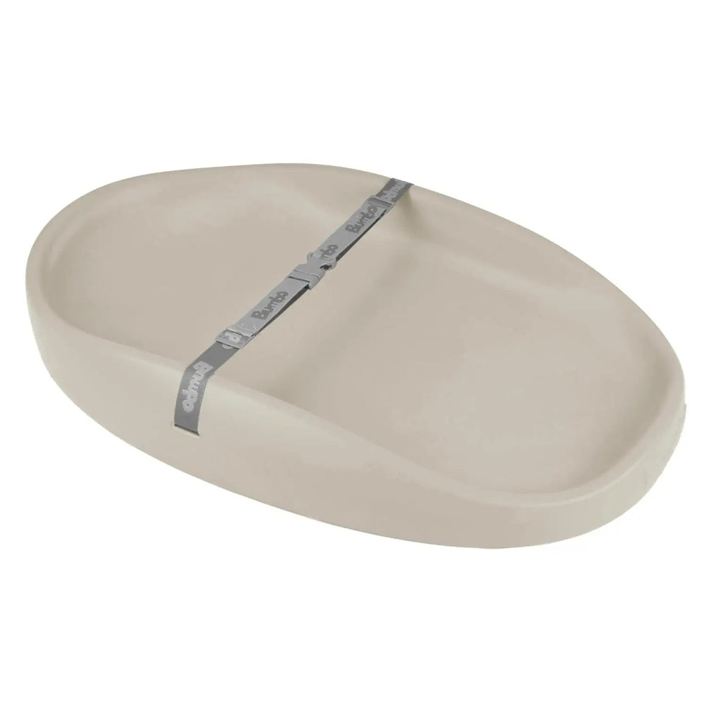 BUMBO Changing Pad beige diaper mat with gray strap fastened across to secure diaper changes.