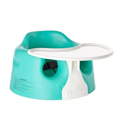 Bumbo Floor Seat turquoise with white detachable tray, infant seated with tray attached on a flat floor.