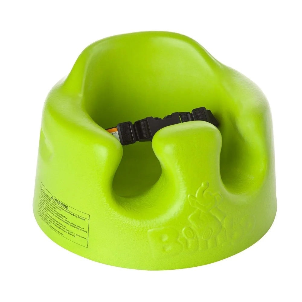 BUMBO Floor Seat lime green booster with a black safety strap buckled across the seat.