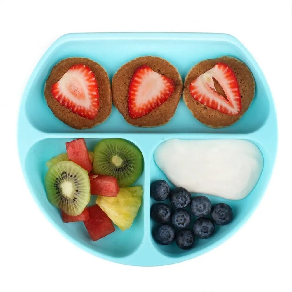BUMKINS Silicone Grip Dish blue, a three-compartment feeding tray shown holding fruit, cookies, and berries