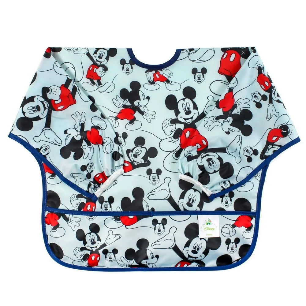 Bumkins Sleeved Bib in light blue with Mickey Mouse print and navy trim, sleeves shown catching messes during mealtime.