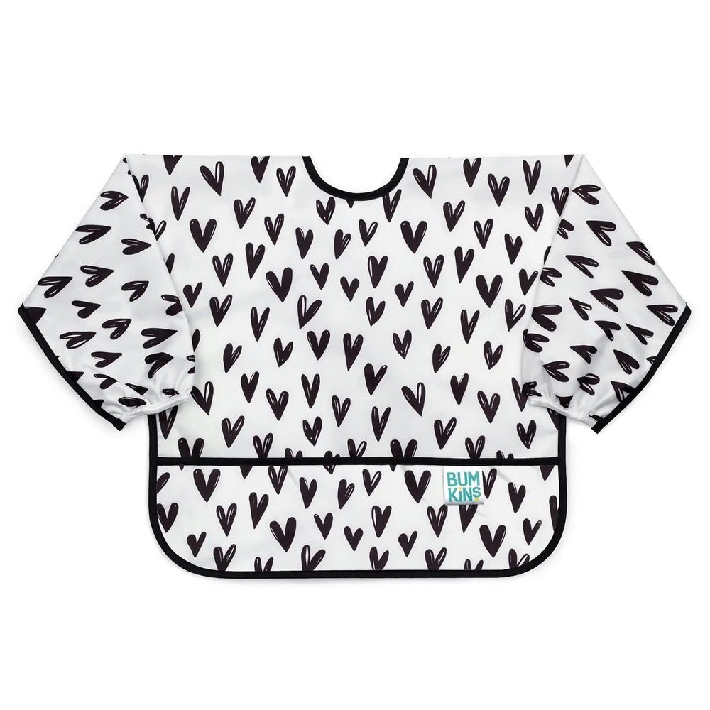 Bumkins Sleeved Bib in white with black heart print; long sleeves catch spills during meals.