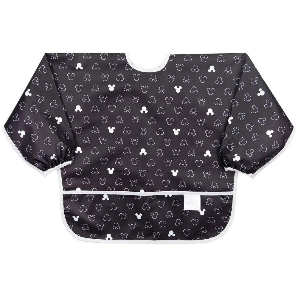 BUMKINS Sleeved Bib in black with white Mickey-style print; child wears long sleeves with white trim to catch spills.