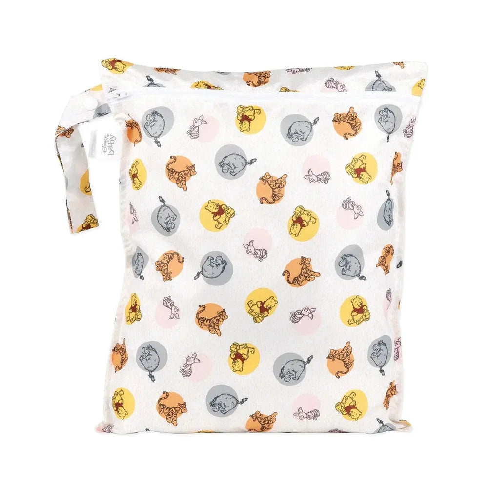Bumkins Wet Bag in white with colorful circle motifs and animal illustrations, laid flat to show pattern and handle.