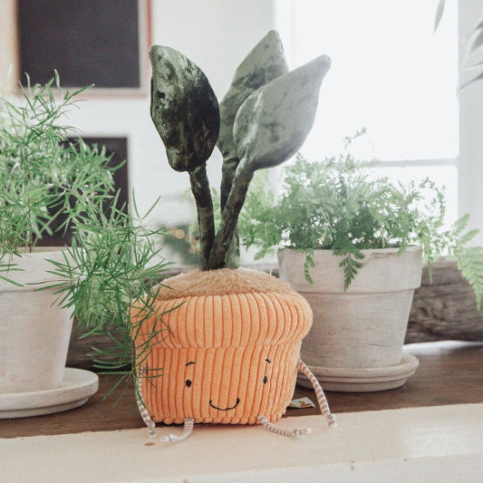 Bunnies By The Bay Windowsill Monstera Plant plush in orange ribbed pot with a smiling face and green leaves