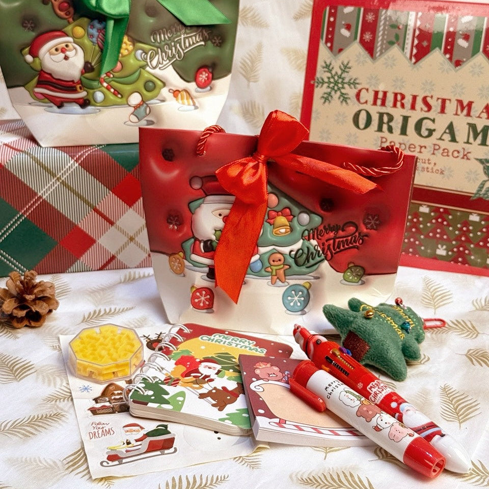 Christmas Stationery Gift Bag by baby enRoute, red gift bag with bow containing festive notebooks, markers and stickers.