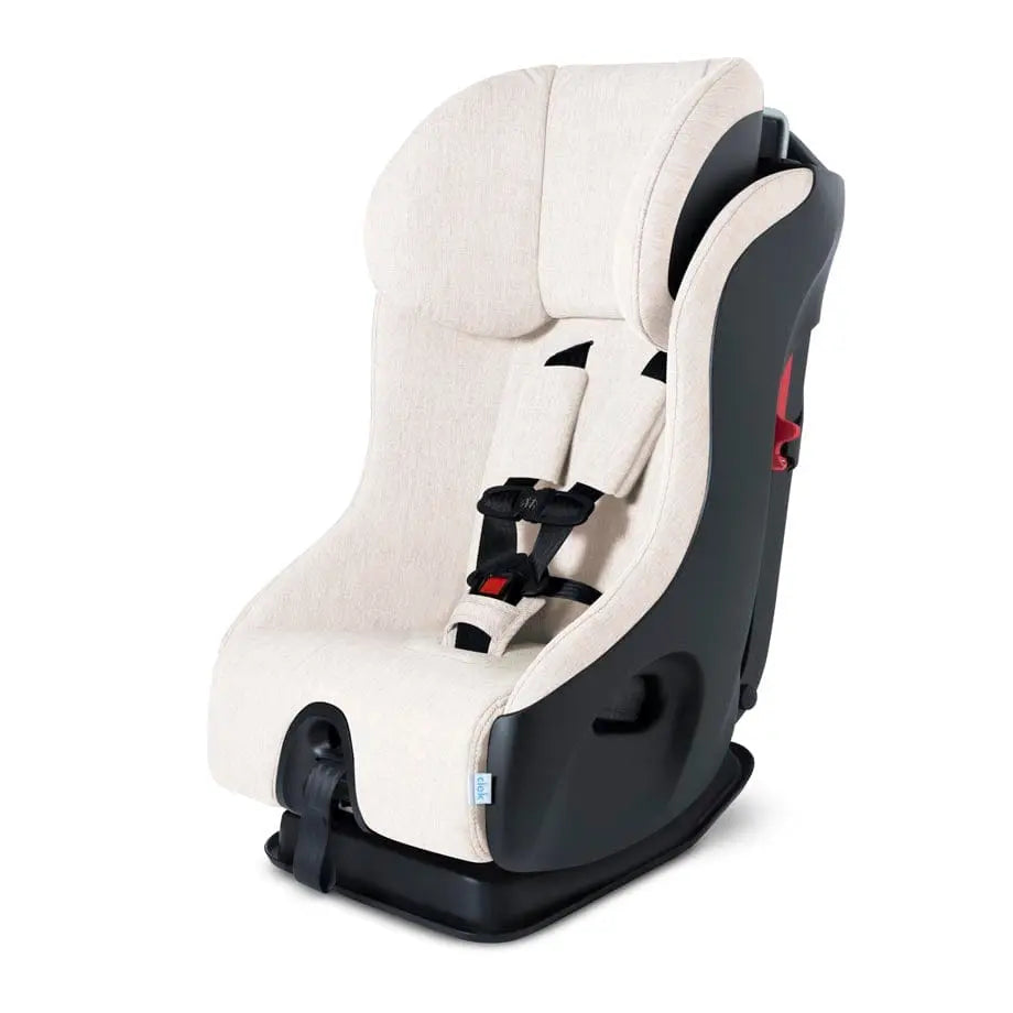 Clek Fllo convertible car seat in beige fabric with black shell, showing secured 5-point harness.