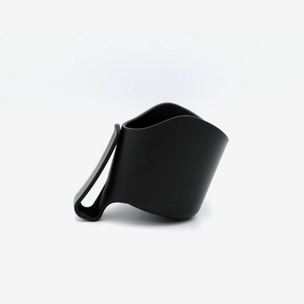 Clek Drink Thingy for Olli car seat, black, clipped to the seat side and holding a bottle.