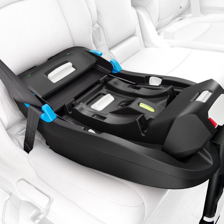 Clek Liing infant car seat base with blue LATCH connectors in a black base, CLEK