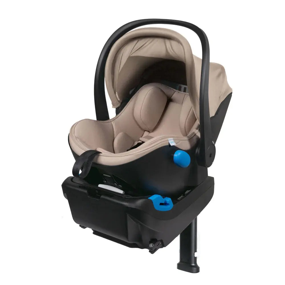 Clek Liing infant car seat in beige fabric with black base, handle in carry position and blue adjustment knob.