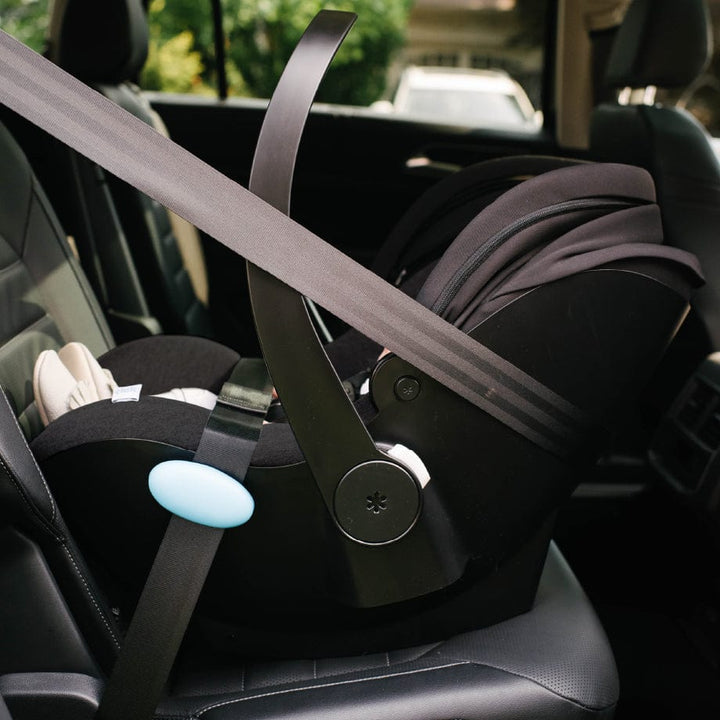Clek Liingo Railroad infant car seat in black installed in a car with blue latch clip