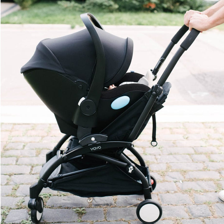Clek Liingo Railroad infant car seat on a black stroller frame with blue accent.