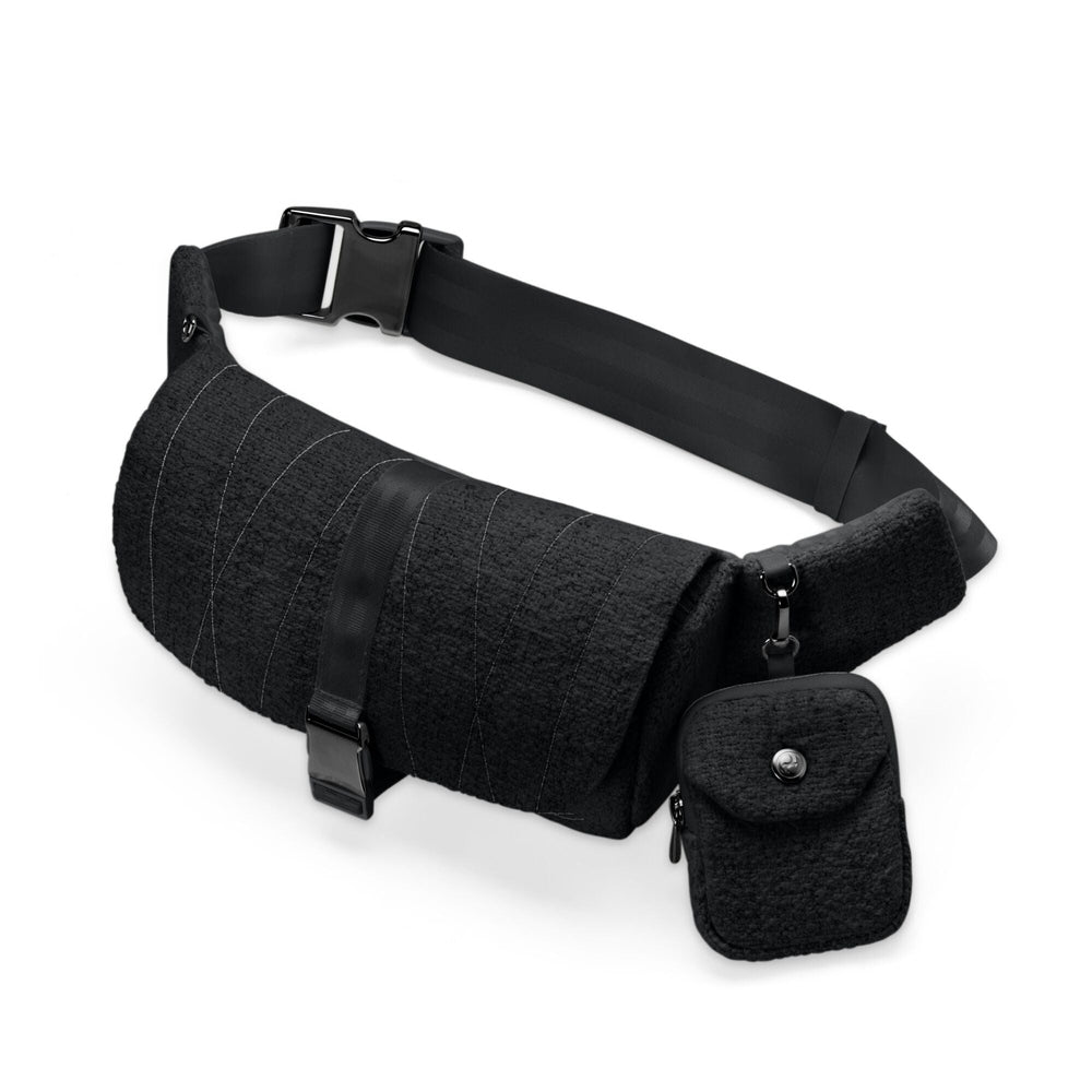 Close-up of the Cybex Belt Bag Boucle black boucle belt bag with diagonal stitching and a small attached boucle pouch with snap; adjustable strap.