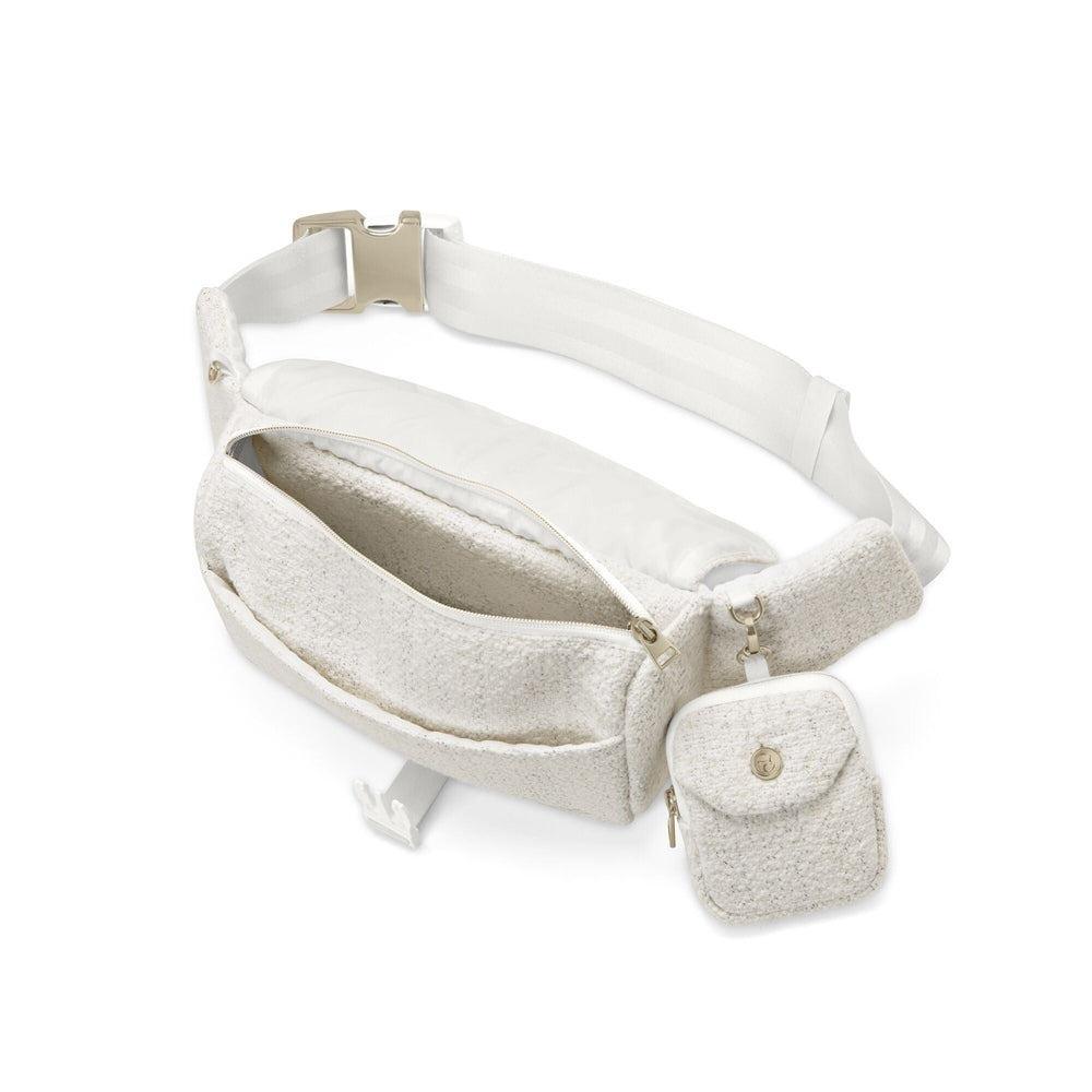 Close-up of the Cybex Belt Bag Boucle cream boucle belt bag with white adjustable strap and small attached pouch with flap.